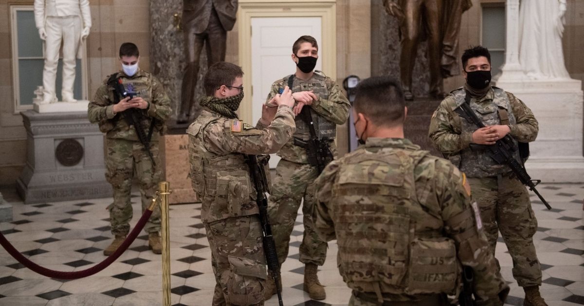National Guard troops are seen in the Capitol's Statuary Hall in Washington on Thursday.