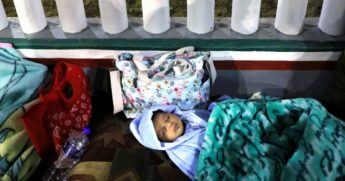 A small child from Honduras sleeps among other minors who are seeking asylum in the United States outside the El Chaparral border crossing in the early morning hours on Friday in Tijuana, Mexico.
