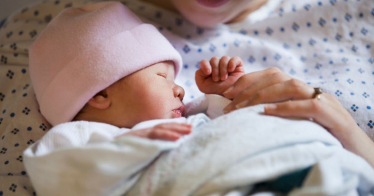 In this stock photo, a newborn baby is held by her mother in the hospital. A new Arizona Democratic committee chair sponsored proposed legislation that would have removed the requirement for doctors to attempt to save a baby born alive in an attempted abortion.