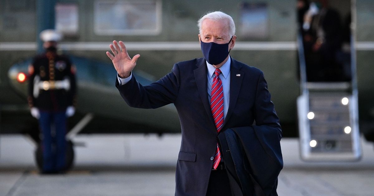 President Joe Biden waves as he makes his way to board Air Force One before departing from Andrews Air Force Base in Maryland on Feb. 5, 2021.