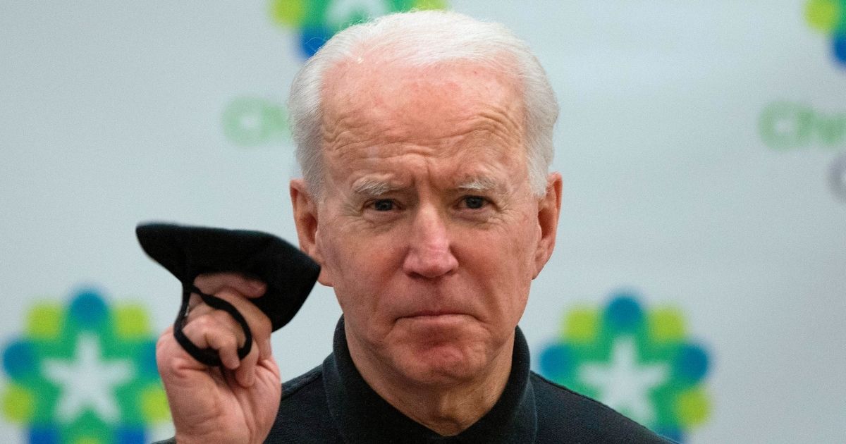 Then-President-elect Joe Biden holds his face mask after receiving the second course of the Pfizer-BioNTech COVID-19 vaccine on Jan. 11, 2021, at Christiana Hospital in Newark, Delaware.