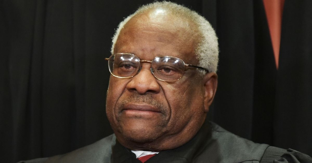 Associate Justice Clarence Thomas poses for the official group photo at the U.S. Supreme Court in Washington on Nov. 30, 2018.