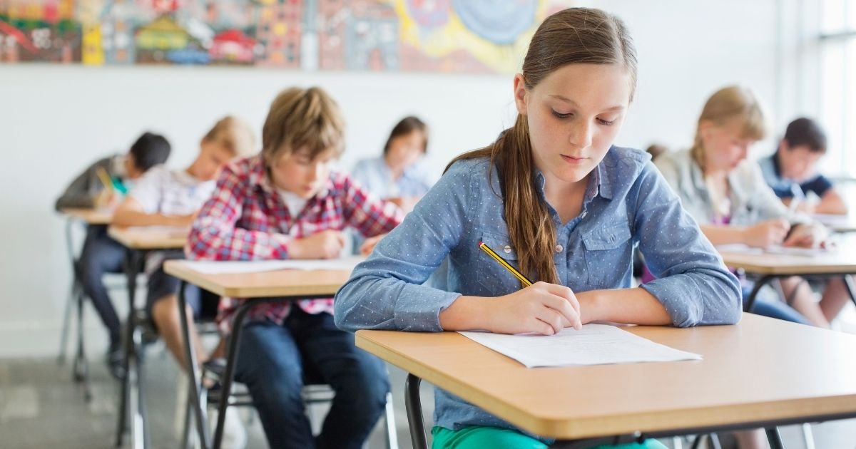 This stock photo portrays children taking a test in a classroom. A recently released survey of 175 pediatric doctors found that the majority of those surveyed agreed children should be allowed to return to in-person learning.