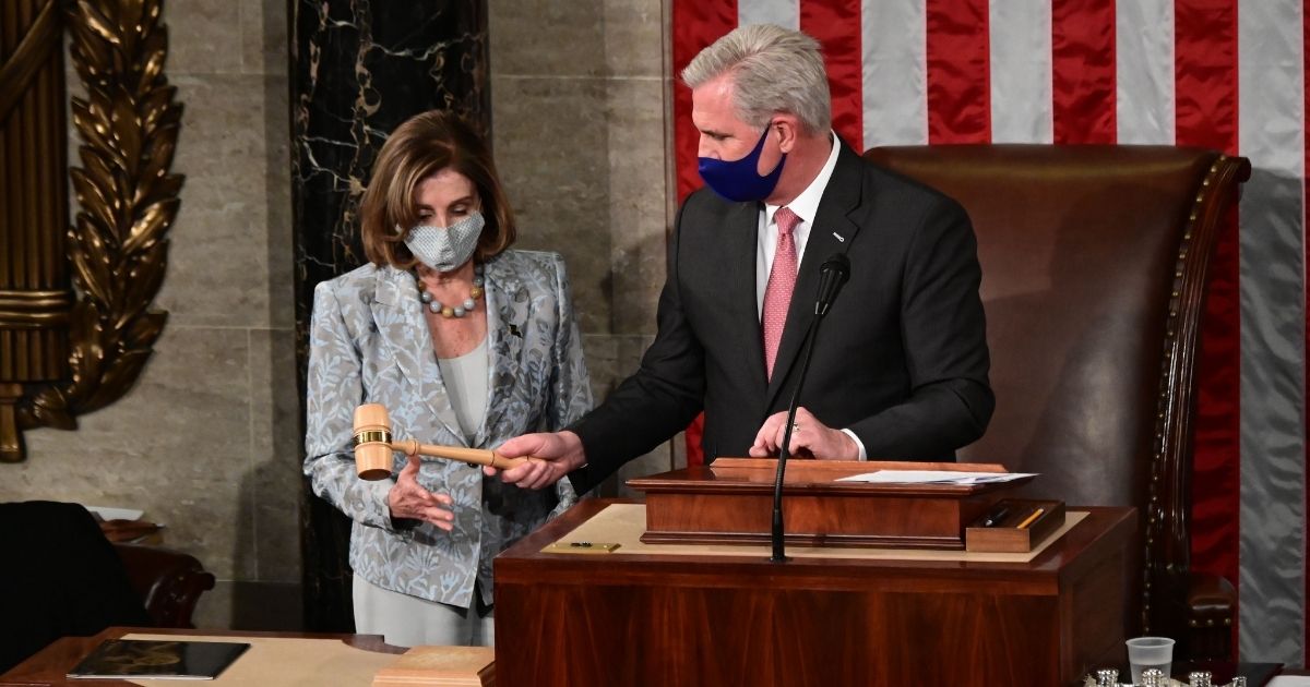 Speaker of the House Nancy Pelosi is handed the Speaker's gavel by House Minority Leader Kevin McCarthy after Pelosi was re-elected in Washington, D.C., on Jan. 3, 2021.