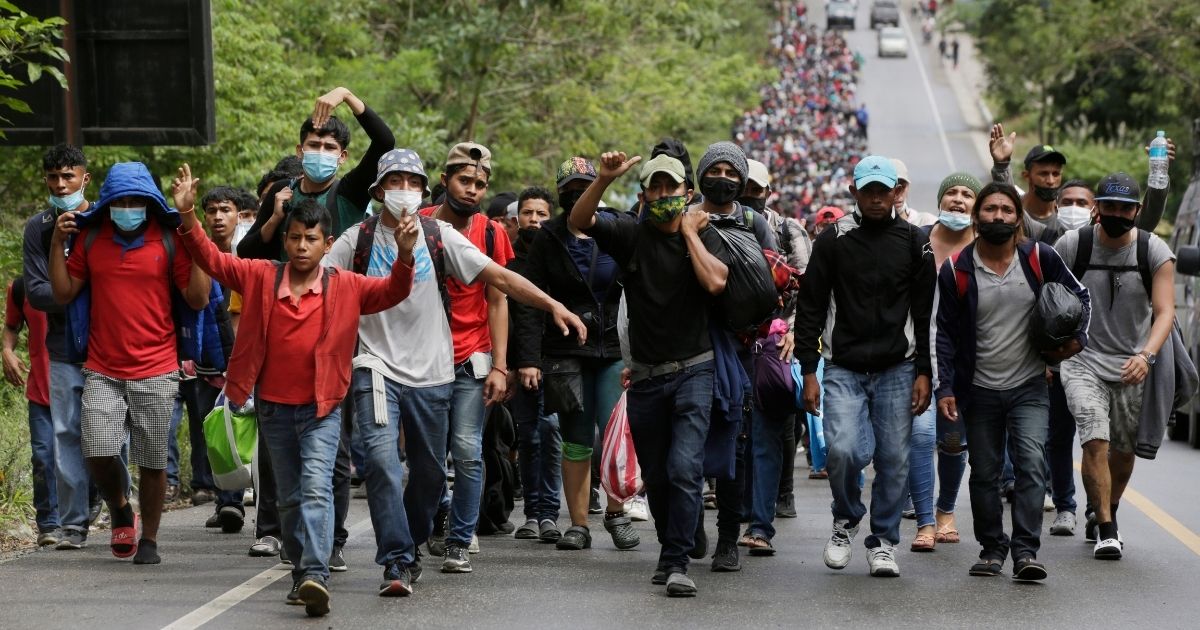 Migrants enter Guatemala after breaking a police barricade at the border checkpoint in El Florido on Jan. 16.