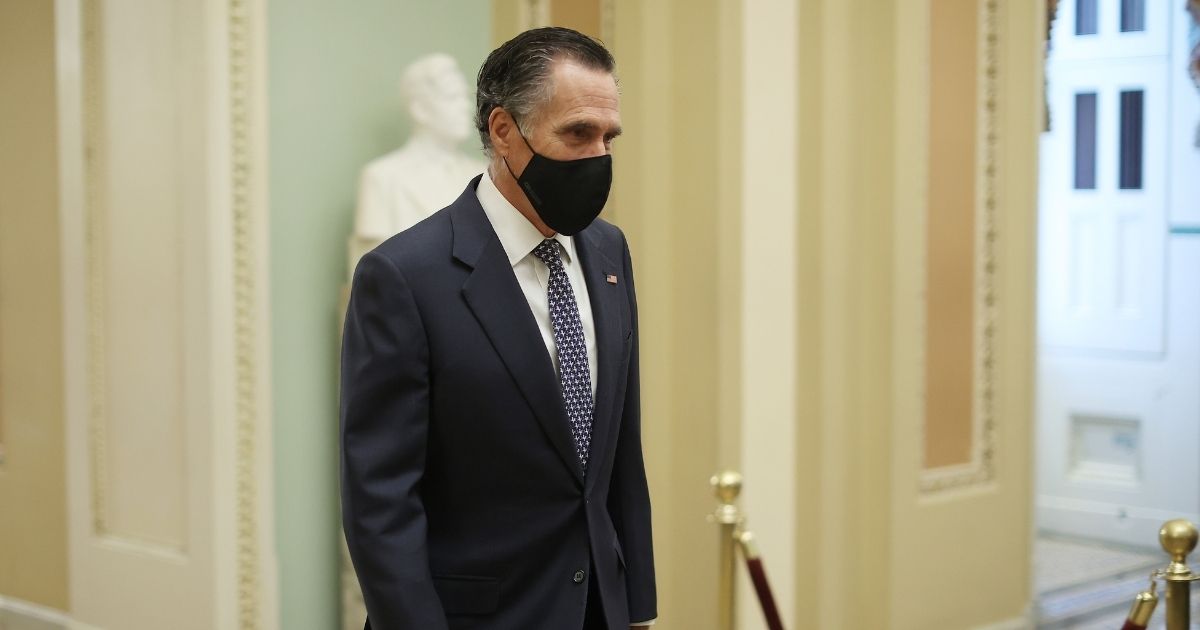 Utah GOP Sen. Mitt Romney walks to the Senate Chamber during the fifth day of former President Donald Trump's impeachment trial at the U.S. Capitol on Saturday in Washington, D.C.