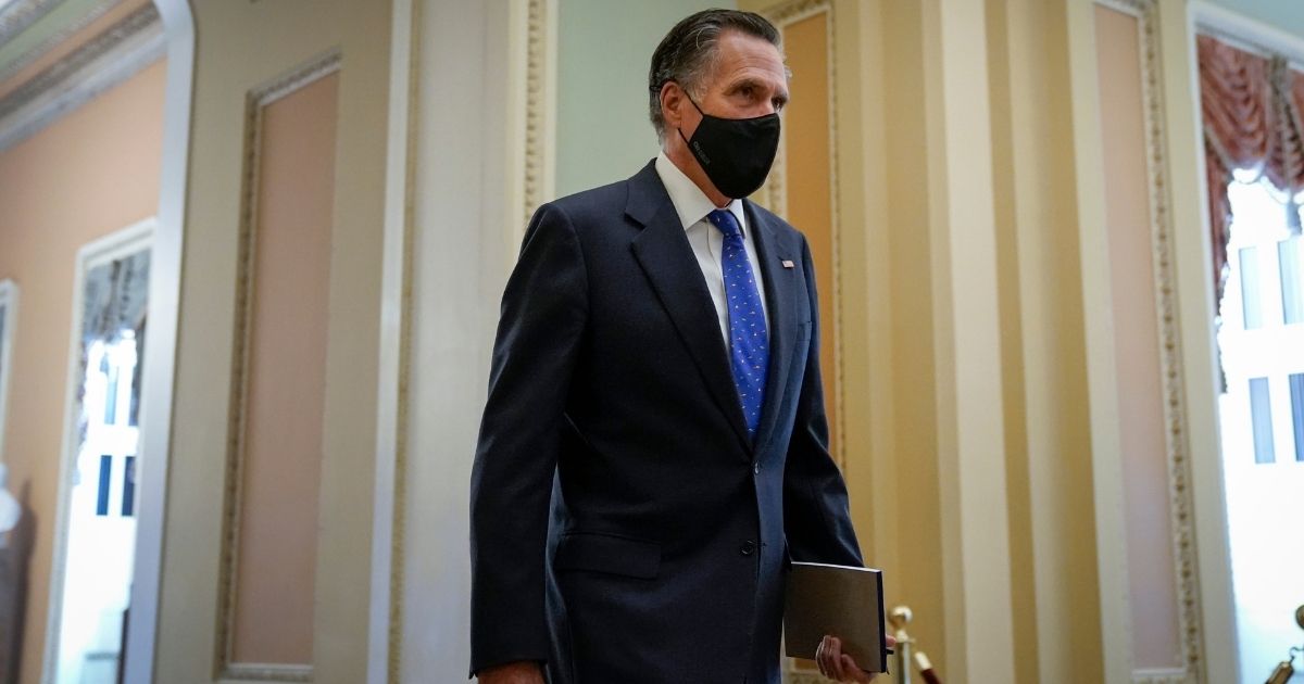 Utah GOP Sen. Mitt Romney walks to the Senate Chamber on the first day of former President Donald Trump's second impeachment trial at the U.S. Capitol on Tuesday in Washington, D.C.