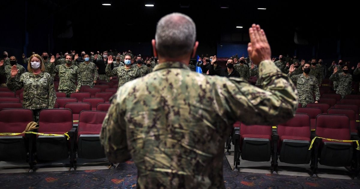 Vice Adm. Roy Kitchener, commander of the Naval Surface Force for the U.S. Pacific Fleet, reaffirms the Oath of Office/Enlistment with participating littoral combat ship officers and enlisted sailors Feb. 10 at the Naval Base San Diego Theater.