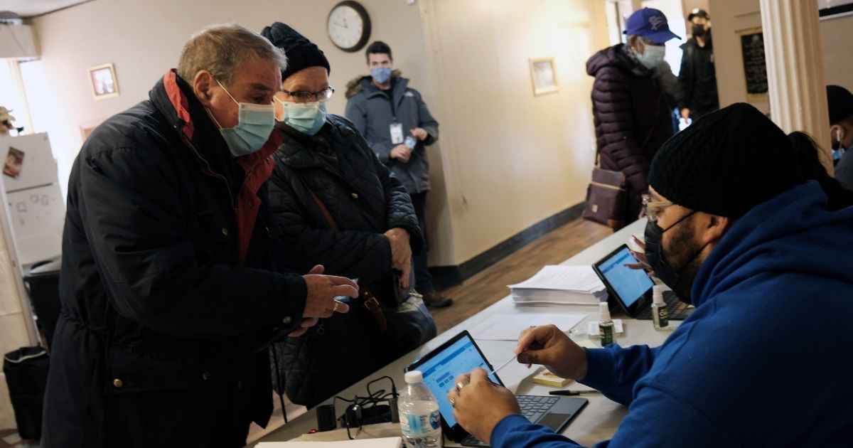 People register to receive a COVID-19 vaccination shot at a pop-up vaccination site at a Bronx church on Feb. 4 in New York City.