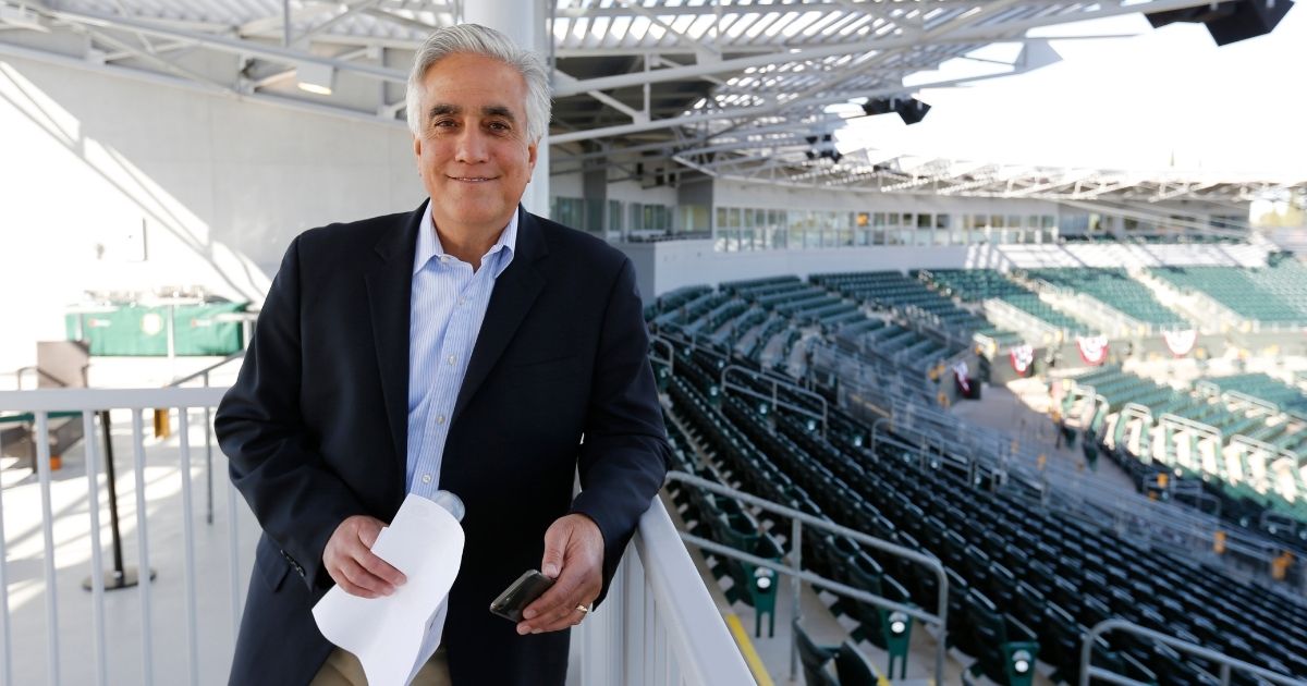 ESPN reporter Pedro Gomez is seen in the stands of Hohokam Stadium in Mesa, Arizona, prior to a spring training game between the Oakland Athletics and the San Francisco Giants on March 3, 2015.