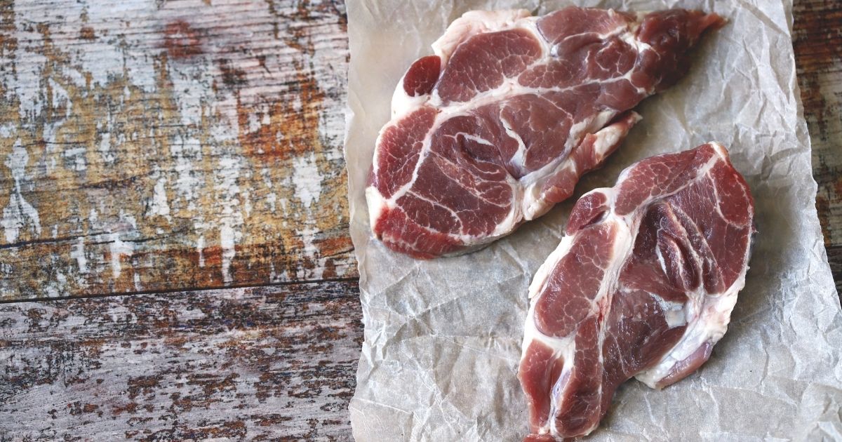Raw pork steaks in paper are pictured in the stock image above.