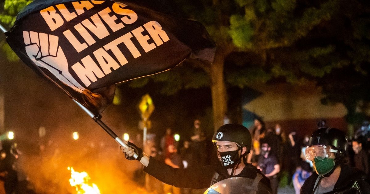 Protesters gather in front of a fire near a police precinct on Sept. 6, 2020, in Portland, Oregon.