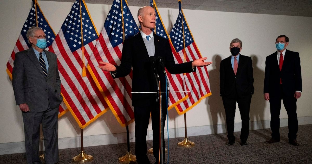 Florida GOP Sen. Rick Scott, center, speaks with Senate Minority Leader Mitch McConnell, left, Missouri GOP Sen. Roy Blunt, second from right, and Wyoming Republican Sen. John Barrasso after the Republican Policy Luncheon on Capitol Hill in Washington, D.C, on Jan. 26, 2021.