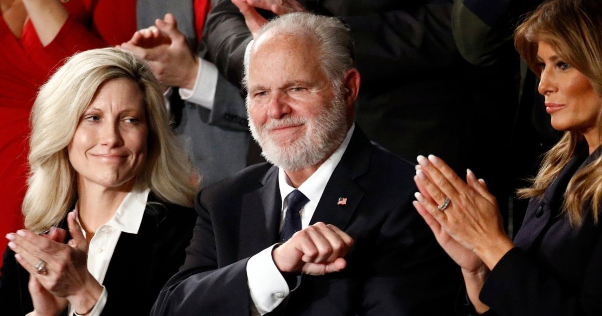 Rush Limbaugh reacts as his wife, Kathryn, left, and Melania Trump applaud after then-President Donald Trump honored him during his State of the Union address on Capitol Hill in Washington on Feb. 4, 2020.
