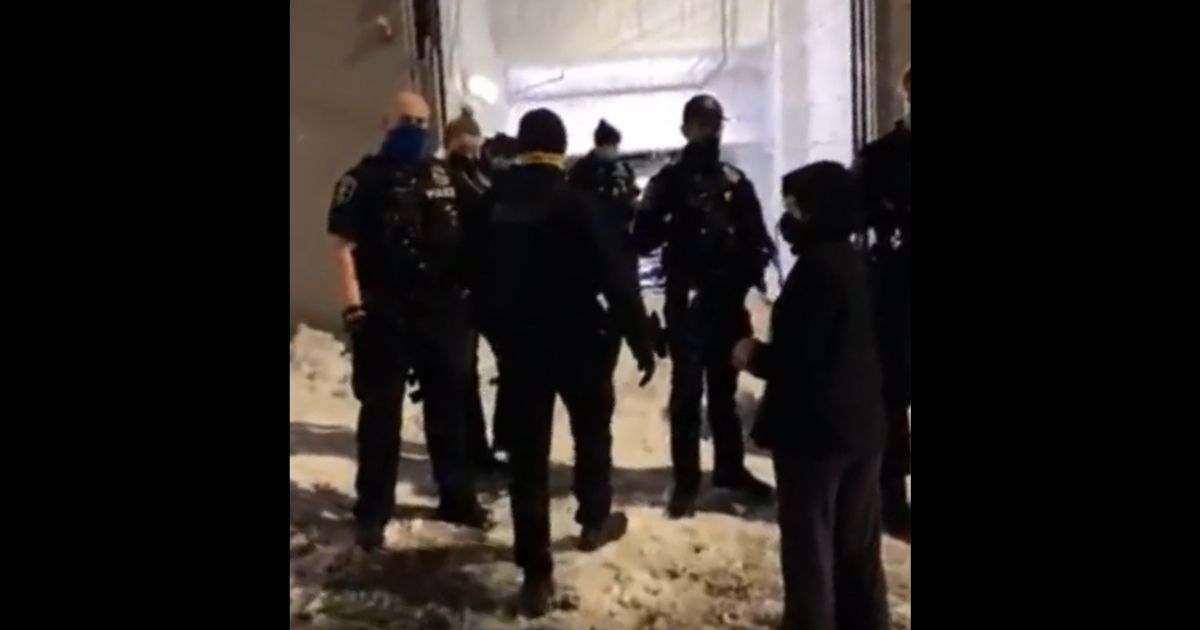 Seattle police officers stand near the blocked garage.