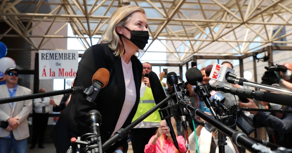 Salon owner Shelley Luther leans in to speak to the media and supporters after she was released from jail in Dallas on May 7, 2020.