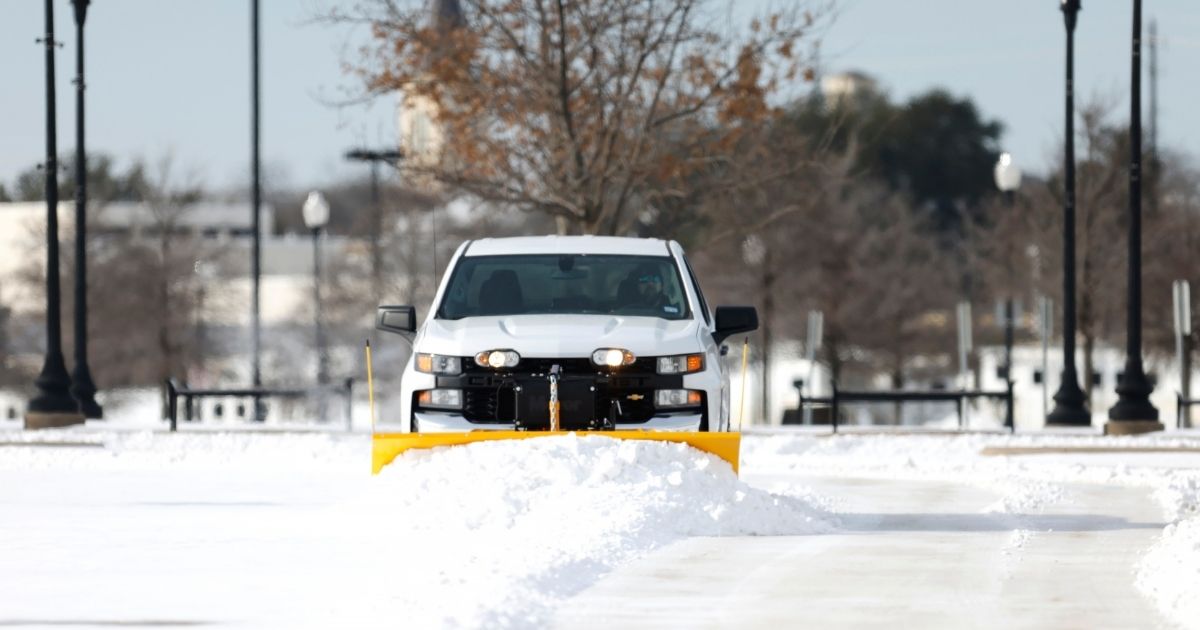 Snow is plowed on the parking lot at Dickies Arena after a snow storm on Feb. 16, 2021, in Fort Worth, Texas.