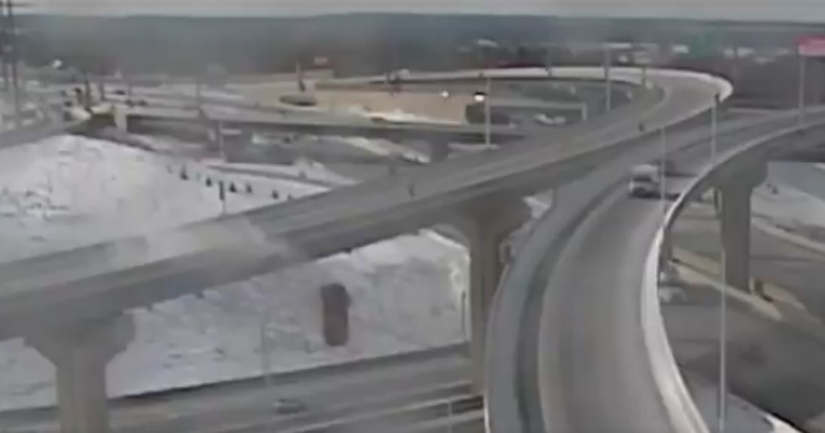 The driver of a vehicle that skidded off an interchange ramp and plunged 70 feet to the highway below reportedly suffered a broken back, neck and legs.