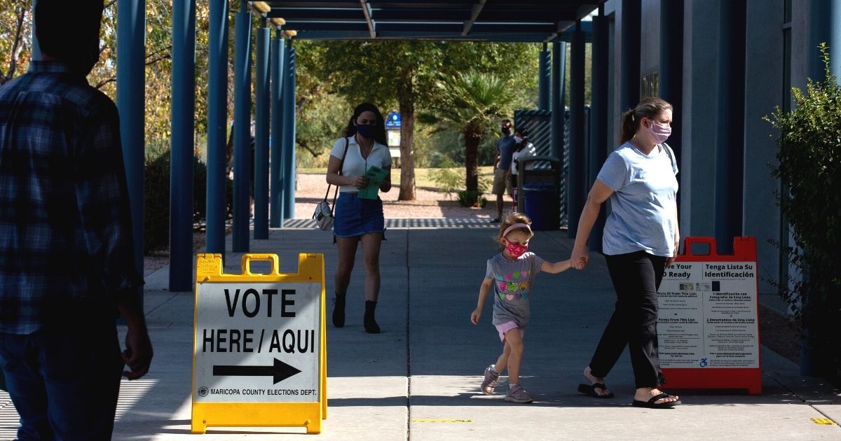 Voters enter the Southeast Regional Library in Gilbert, Arizona, to cast their ballots in the Nov. 3 general election.
