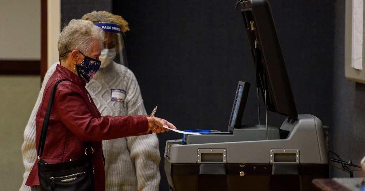 Dorothy Higginbotham, 90 years old, places her ballot into a tabulating machine on Election Day at Church of Jesus Christ of latter-day Saints on Nov. 3, 2020, in Fayetteville, North Carolina.
