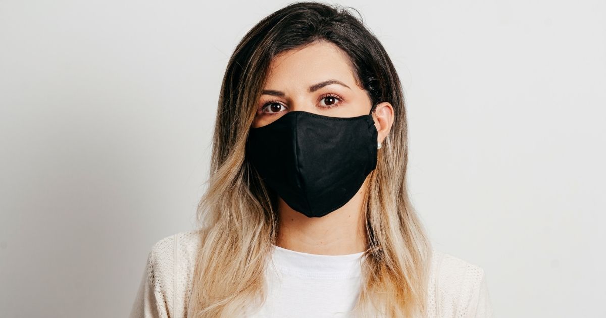 This stock photo portrays a woman wearing a black mask. A new study has revealed that the COVID-19 virus is capable of staying on polyester masks for up to three days, and can stay on cotton masks for 24 hours.