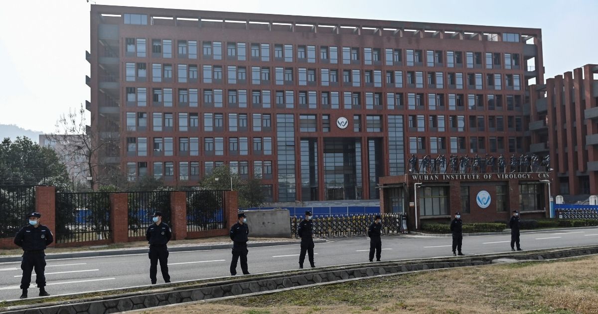 Police officers stand outside the Wuhan Institute of Virology in China's central Hubei province on Feb. 3 as members of the World Health Organization team investigating the origins of the coronavirus visit the facility.