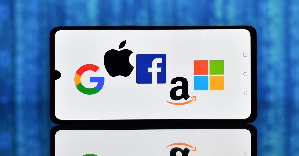 The logos of Google, Apple, Facebook, Amazon and Microsoft are displayed on a smartphone on Dec. 18, 2020, in London. (