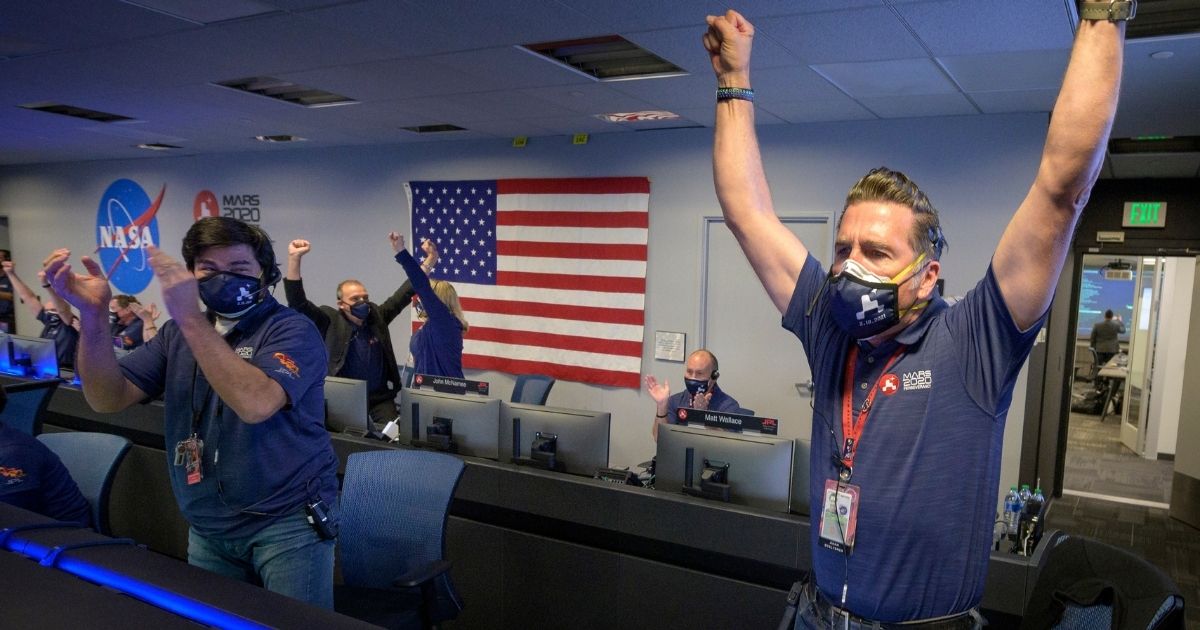 Members of NASA's Perseverance rover team react in mission control after receiving confirmation the spacecraft successfully touched down on Mars on Feb. 18, 2021, at NASA's Jet Propulsion Laboratory in Pasadena, California.