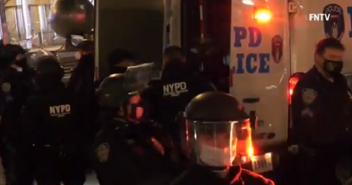New York City police officers gather as a protest turns violent Friday night.