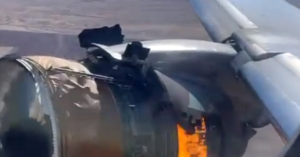 A plane engine burns on a United Airlines flight Saturday before the aircraft was forced to return to Denver International Airport, aborting a flight to Honolulu.