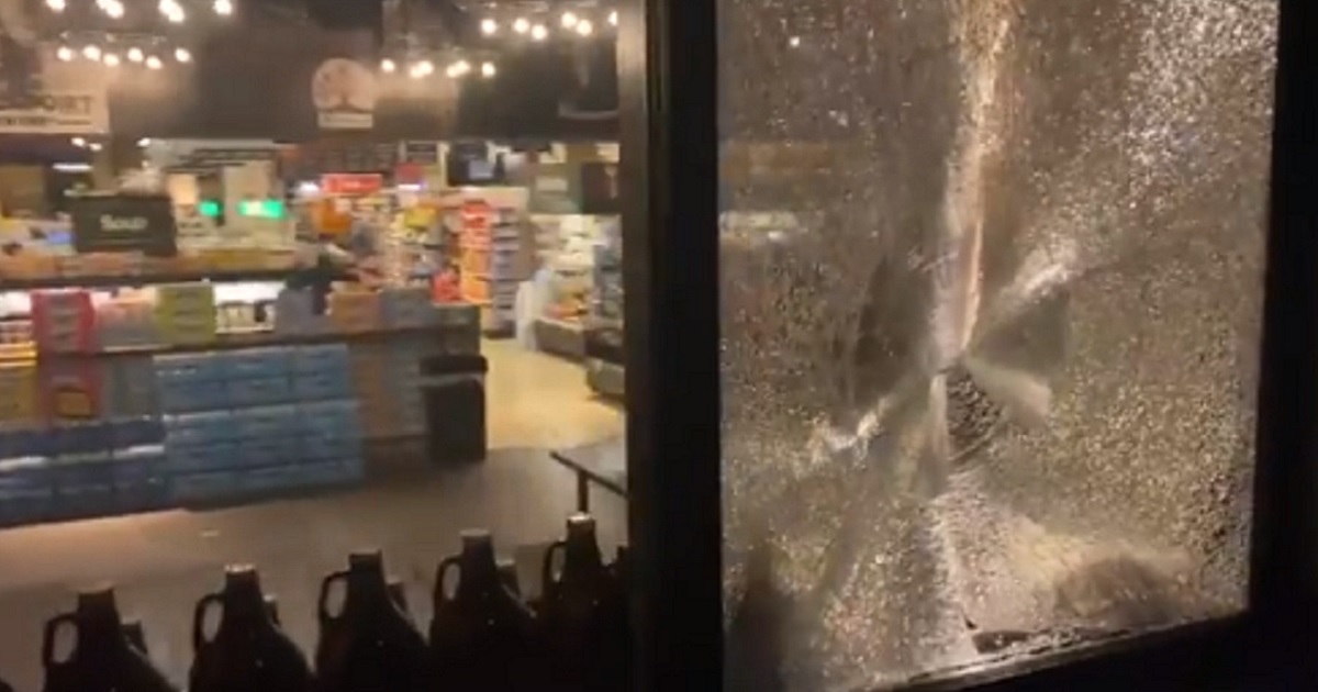 A grocery store window is shattered after violent demonstrations Satuday in Portland, Oregon.