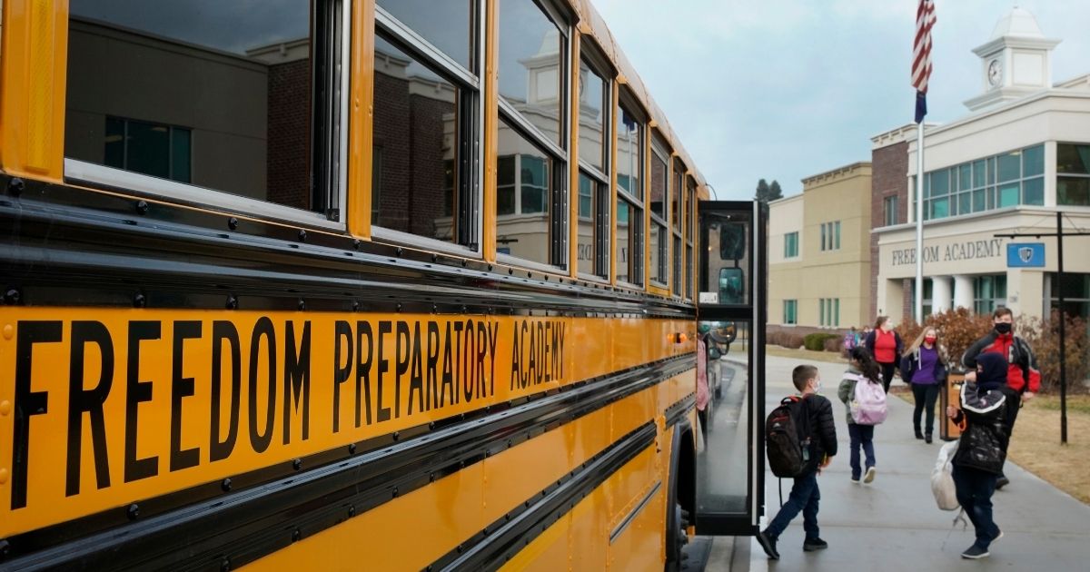 Students arrive for school at Freedom Preparatory Academy on Feb. 10, 2021, in Provo, Utah.