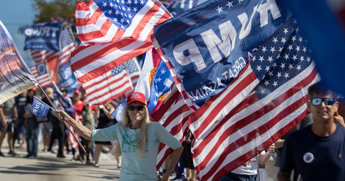 Supporters of former President Donald Trump gather near Trump's Mar-a-Lago home on Feb. 15, 2021, in West Palm Beach, Florida.