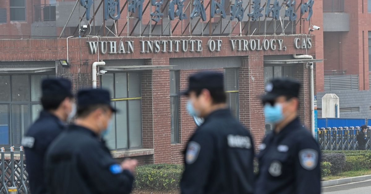 Security personnel stand guard outside the Wuhan Institute of Virology as members of a World Health Organization team investigating the origins of the coronavirus make a visit to the research center in Wuhan, China, on Feb. 3, 2021.