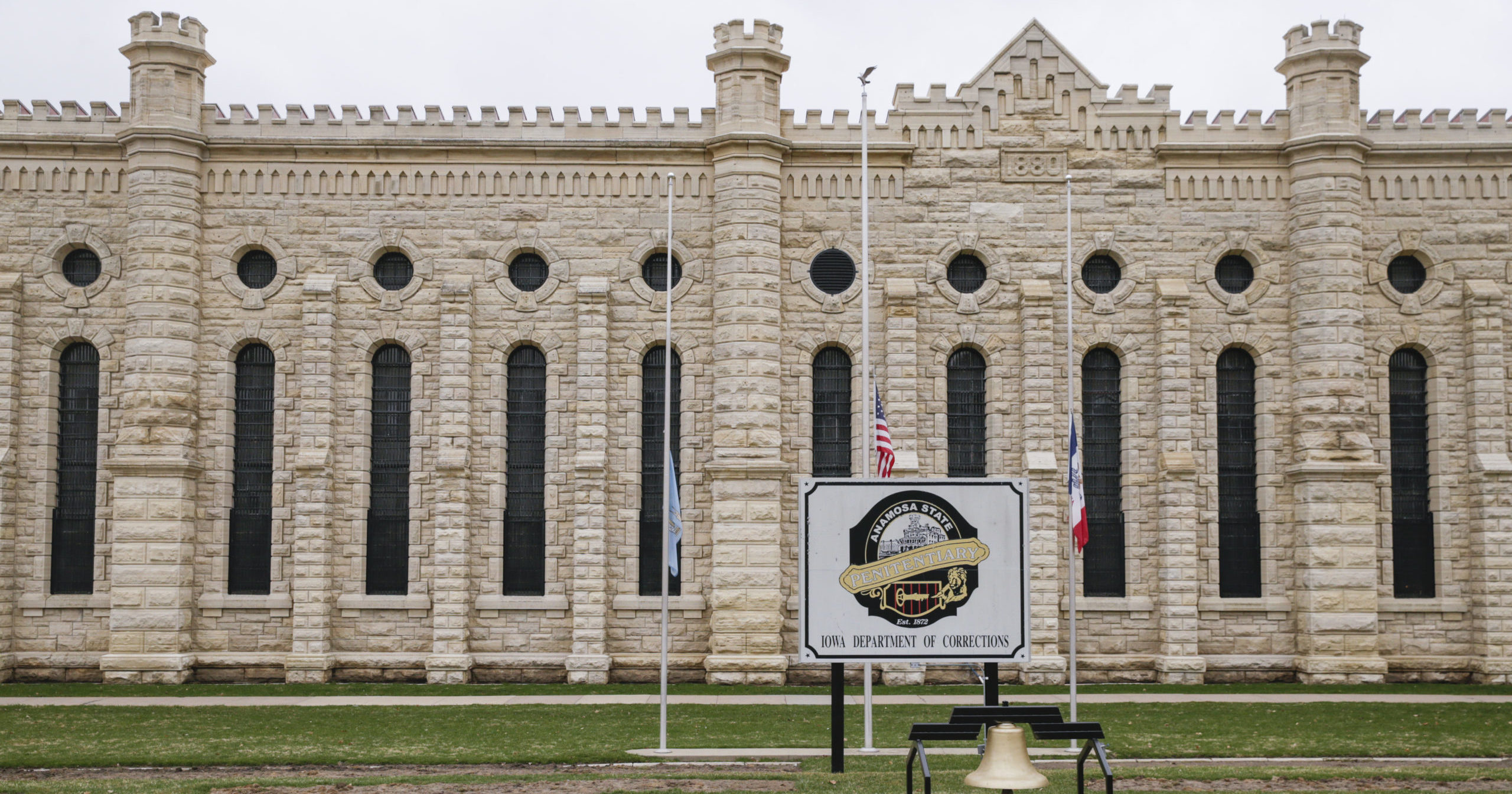 Flags are flown at half staff in memory of the two prison workers killed in an escape attempt at the Anamosa State Penitentiary in Anamosa, Iowa, on March 24, 2021.