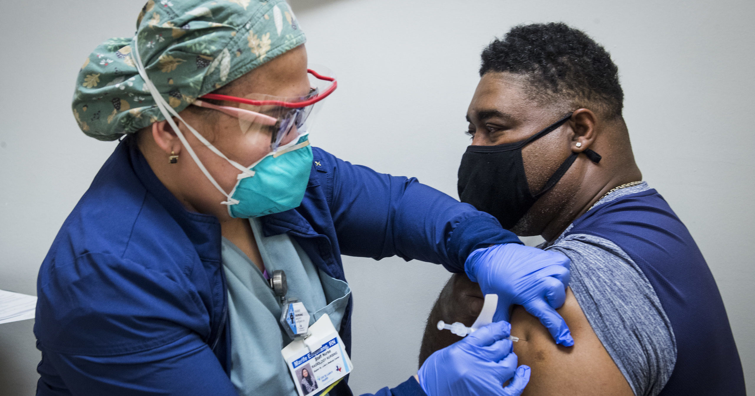 Nurse Marife Edquilang administers a dose of Pfizer's COVID-19 vaccine to Anthony Monroe during a vaccination drive at Texas Southern University in Houston on Feb. 11, 2021.