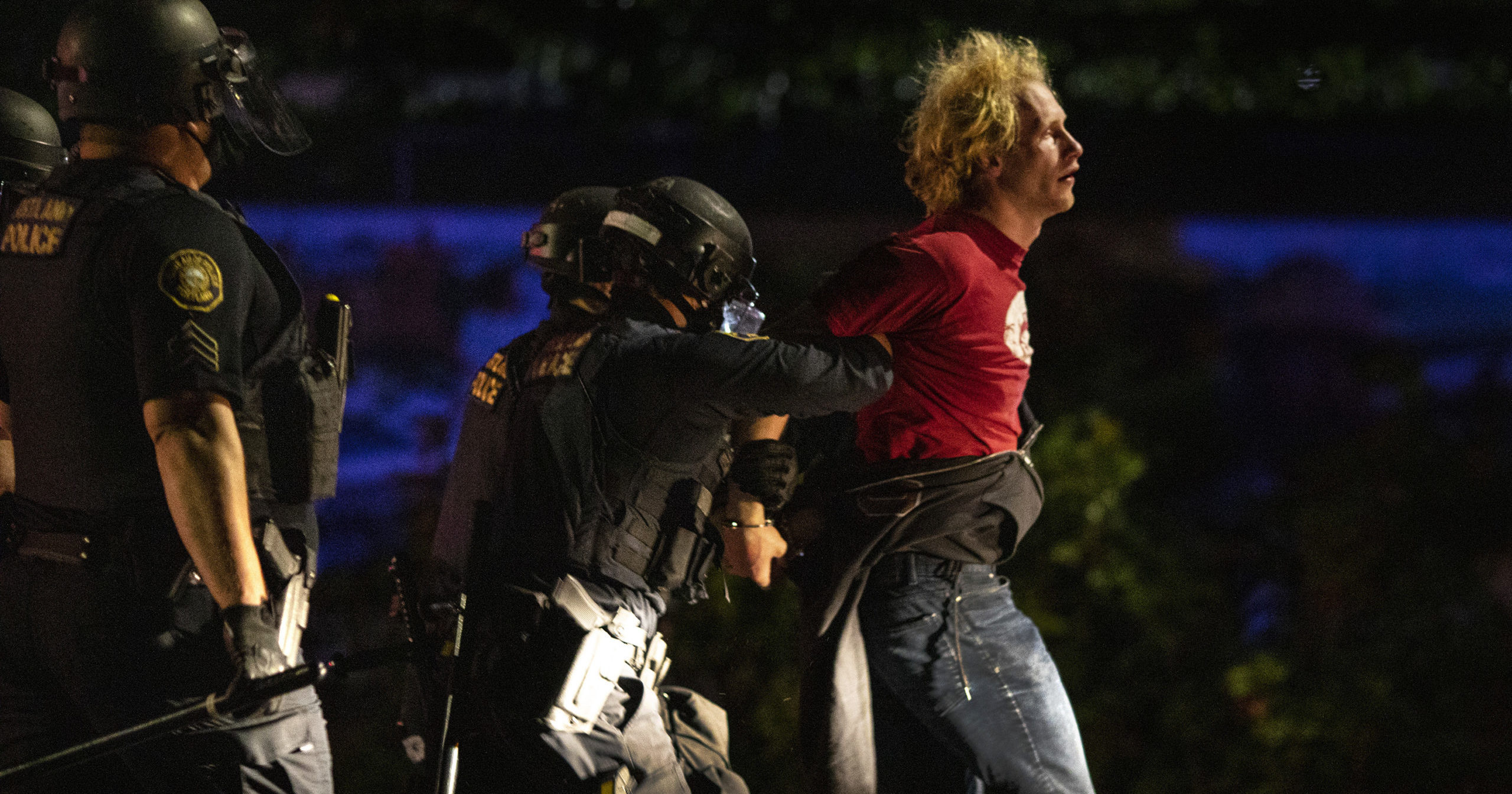 Police make arrests at the scene of a protest at a Portland police precinct in Portland, Oregon, on Aug. 30, 2020.