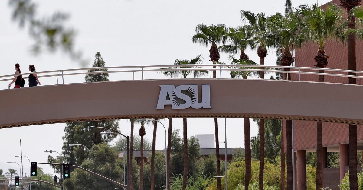 Pedestrians cross over University Ave on the campus of Arizona State University on July 25, 2018, in Tempe, Arizona.