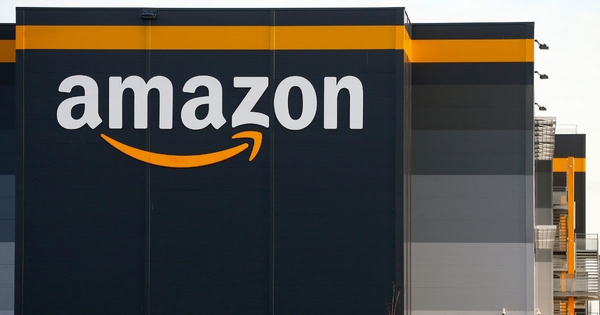 The logo of Amazon is seen on the facade of the company logistics center on Nov. 20, 2020, in Bretigny-sur-Orge near Paris, France.