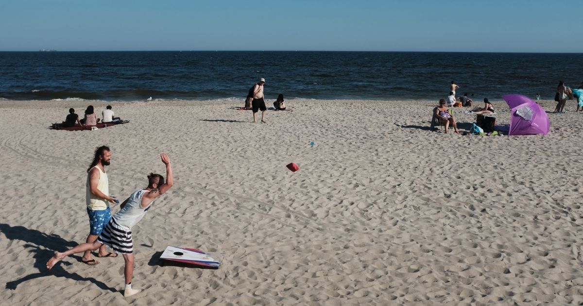 People enjoy an afternoon at the beach on the last day of school in New York on June 26, 2019, in New York City.