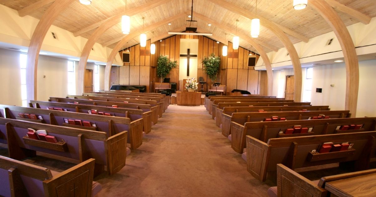 This stock photo portrays an empty church sanctuary. Nearly all of the charges against Pastor James Coates were dropped, after the pastor of GraceLife Church near Edmonton was arrested for a series of Public Health Act offenses when he chose not to restrict his church's attendance to 15 percent capacity.