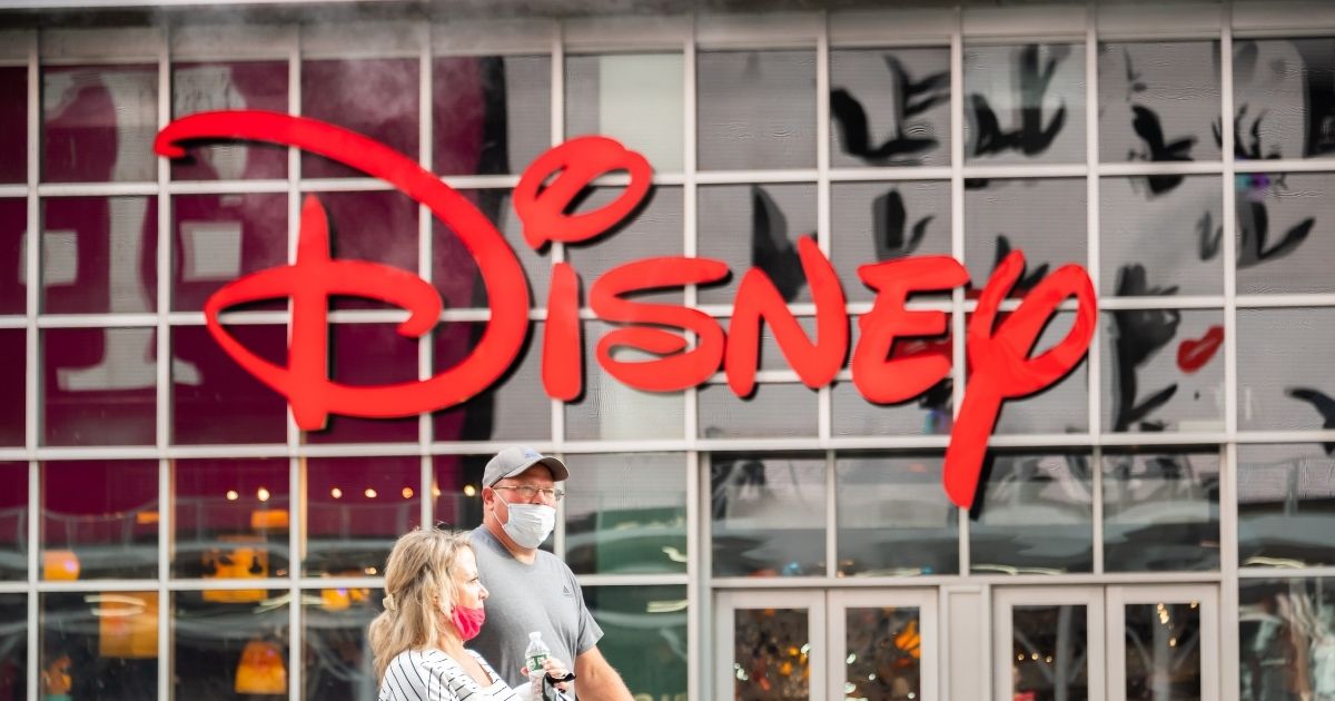 People wear face masks outside the Disney store in Times Square on Oct. 23, 2020, in New York City.