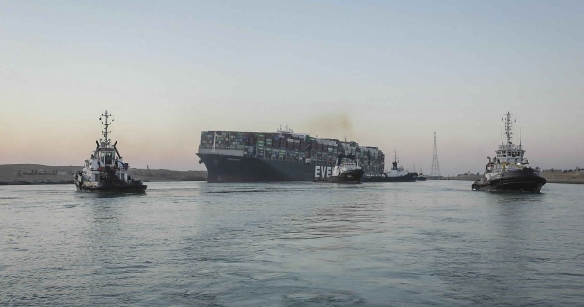 In this photo released by Suez Canal Authority, the Ever Given, a Panama-flagged cargo ship is pulled by tugboats, in the Suez Canal, Egypt, on Monday.