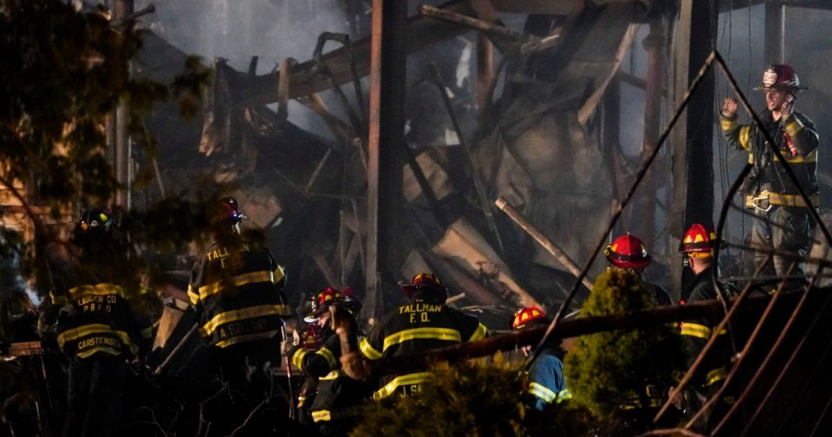 Firefighters work at the scene of a fire that burned down the Evergreen Court Home for Adults on Tuesday in Spring Valley, New York.