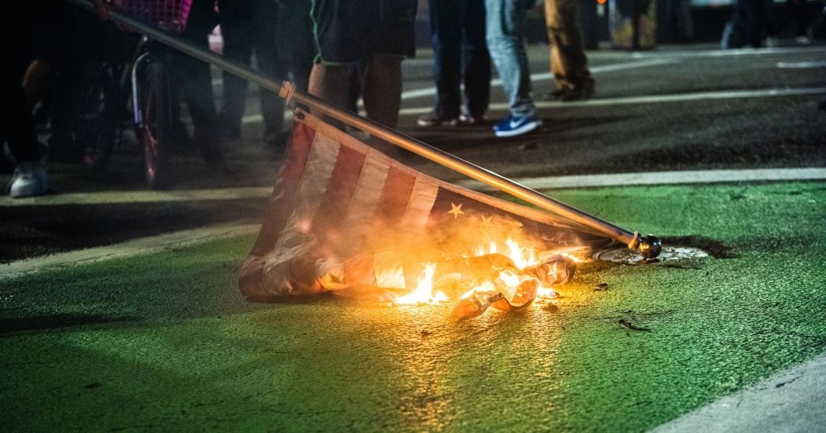 Protesters burn an American flag during a Black Lives Matter demonstration in Portland, Oregon, on Nov. 4.