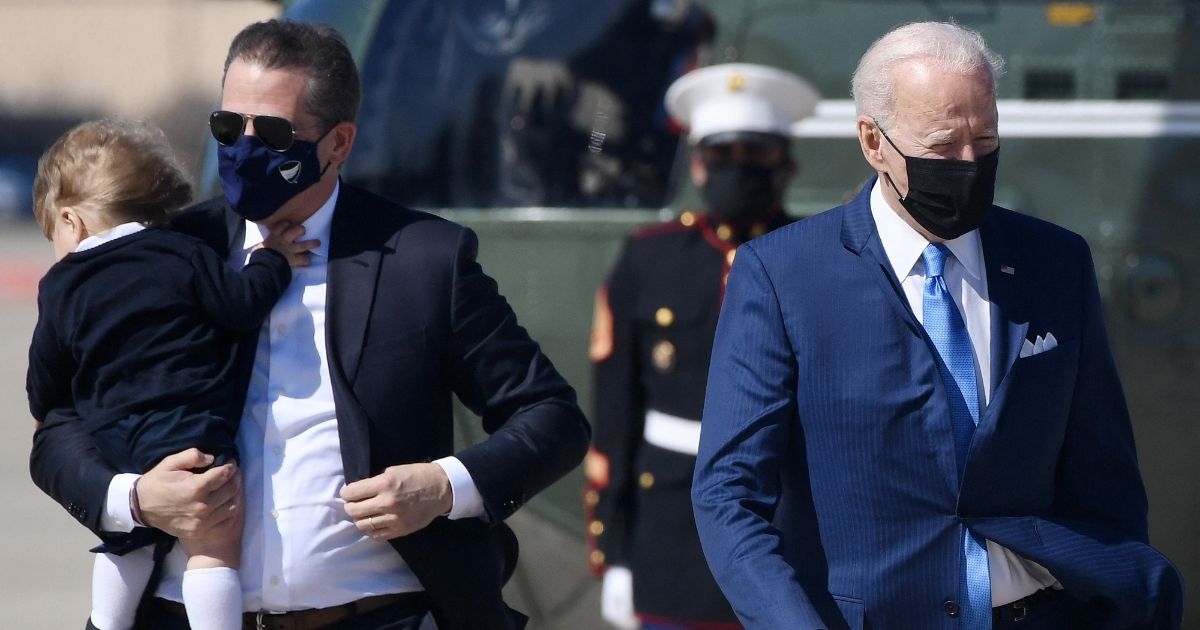 Hunter Biden carries his son, Beau, while walking with his father, President Joe Biden, to board Air Force One at Joint Base Andrews, Maryland, on Friday.