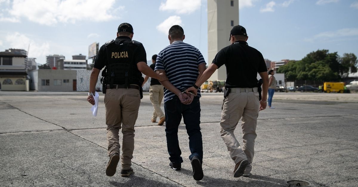 Guatemalan police escort a convicted criminal who arrived on an ICE deportation flight from Brownsville, Texas, on Aug. 29, 2019, to Guatemala City.