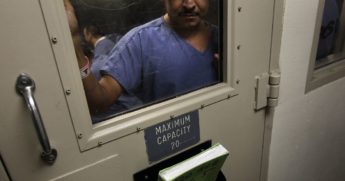 A man stands in a holding cell at the U.S. Immigration and Customs Enforcement detention facility for illegal immigrants in Florence, Arizona, on July 30, 2010.