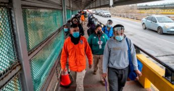 Migrants approach the U.S. border on Gateway International Bridge in Brownsville, Texas, on March 2, 2021.President Biden announced that he was ending the Migrant Protection Protocol enacted under former President Donald Trump that sent asylum seekers back to Mexico as they awaited their trial dates.