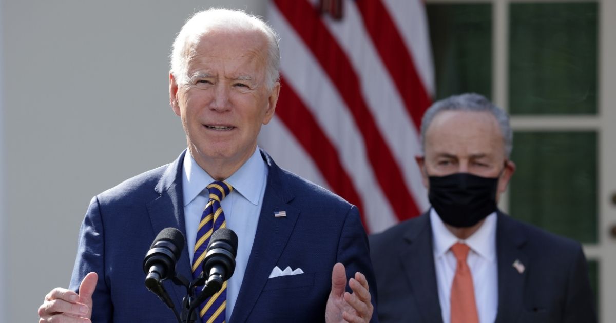 President Joe Biden, left, speaks as Democratic Senate Majority Leader Chuck Schumer listens during an event on the American Rescue Plan in the Rose Garden of the White House on Friday in Washington, D.C.